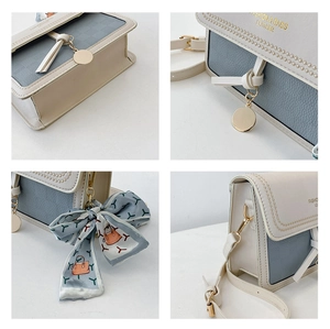 Detail of color-block square bag with leather texture, tassel charm and printed silk scarf
