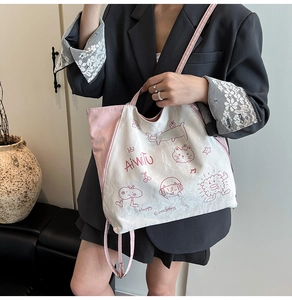 Detail of white and pink tote bag with cartoon graffiti and Happy Everyday print