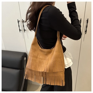 Detailed side view of a brown vintage hobo bag with tiered long fringe tassels