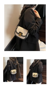 Detail of canvas saddle bag with black leather trim and contrast stitching on steps