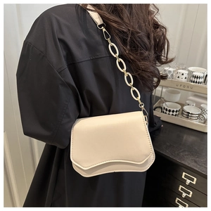 Close-up of off-white PU leather bag featuring unique asymmetric wavy flap and gold chain strap