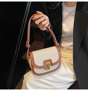 Detail of vintage saddle bag featuring canvas leather splicing and contrast stitching