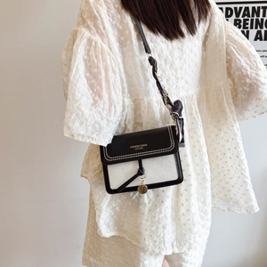 Minimalist black and white square shoulder bag with rivet trim and silk scarf strap detail