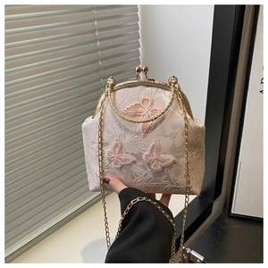 Macro detail of lace fabric with 3D butterfly embroidery on elegant qipao chain bag