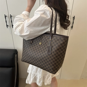 Classic dark brown tote bag with vintage monogram print and elegant shoulder handles