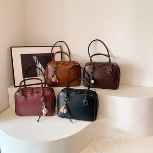 Retro Boston tote bags in brown, coffee, red, and black on a white tiered display