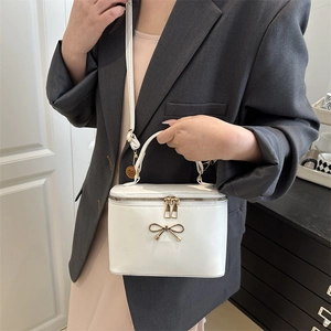 French style white box handbag with gold bow buckle and adjustable crossbody strap