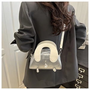 Macro shot of silver shell bag showing metallic shell charms and fashion bags logo print