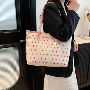 Floral bear print tote bag with pink heart patterns and quilted stitch detail shown on model