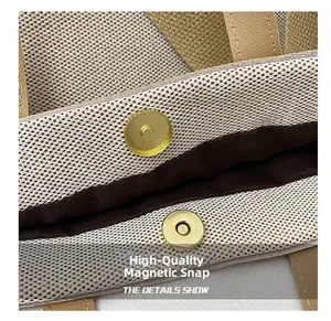 Close-up of golden magnetic clasp on a textured woven tote bag with brown lining