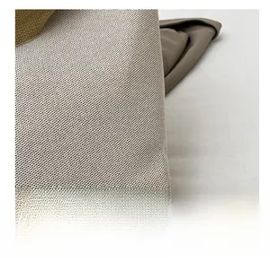 Detailed macro view of the cream mesh knit fabric texture on a minimalist tote bag