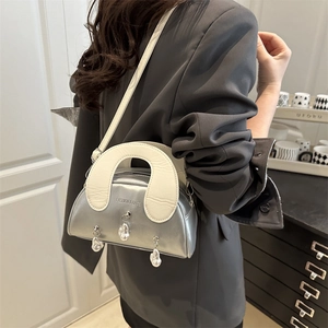 Silver metallic shell handbag with white handles and heart pearl charm detail