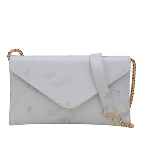 Minimalist white envelope bag with floral print and gold chain strap in a studio shot
