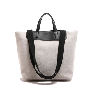 Large minimalist canvas tote bag with black contrast trim and wide shoulder strap