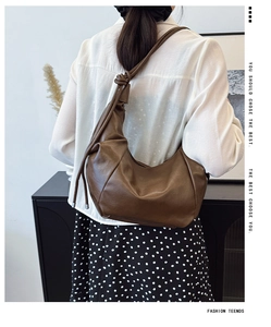 Deep brown soft leather hobo bag worn by model, showing its size and natural drape