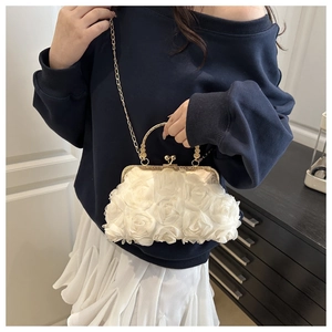 Detail of white 3D rose evening clutch with gold metal handle and chain strap