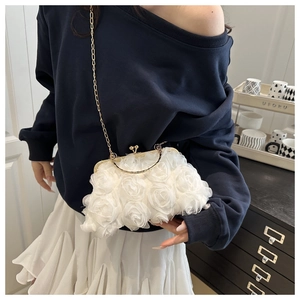 Detail view of 3D rose flower evening bag with gold chain and metal sphere clasp