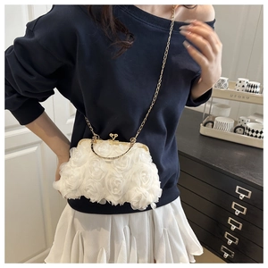 Detail of white 3D floral evening clutch bag with gold chain and organza rose texture