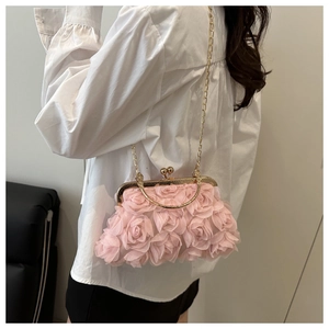 Close-up of light pink rose floral evening bag with gold chain and round handle