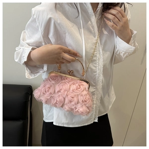 Detail of light pink 3D rose petal handbag with gold metal frame and chain strap