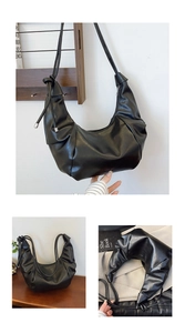 Detailed view of black pleated dumpling bag featuring silver metallic hardware and knots