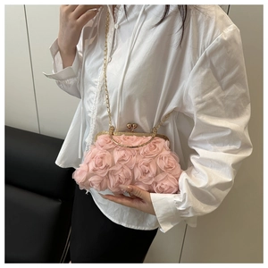 Detail of pink 3D rose flower evening clutch with gold metal clasp and chain strap