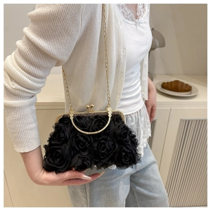 Detail of elegant black mesh rose clutch bag with golden clasp and chain strap