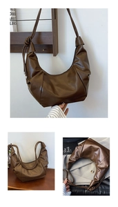 Detail of vintage brown croissant bag with pleated PU leather texture and knotted strap