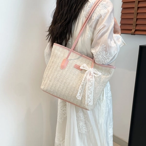 Large capacity woven straw tote bag with pink leather trim and white lace bow detail