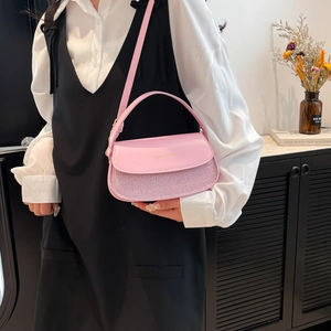 Pink minimalist underarm bag with shimmering texture and adjustable strap for women