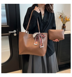 Detail of brown tote bag set with matching zipper pouch and decorative silk scarf detail