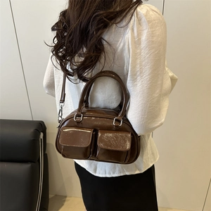 Brown high-gloss underarm tote bag with front pockets and adjustable shoulder strap