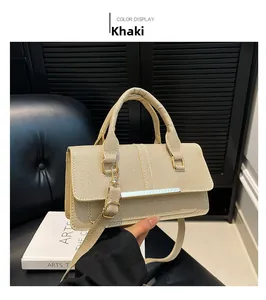 Detail of khaki crossbody bag showing twill fabric texture and gold metal bar buckle