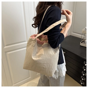 Lifestyle view of women vintage tote bag with pink drawstring in minimalist room