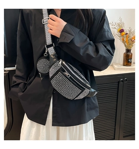 Detail of black rhinestone chest bag with herringbone strap and small round pouch
