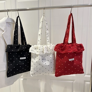 Polka dot chiffon tote bags with ruffle trim in black, cream, and red colors