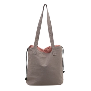Minimalist nylon tote bag in taupe with coral drawstring lining for daily commute