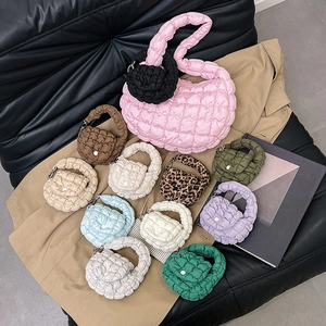 Stylish mini cloud puffer bags in multiple colors like pink and blue on trench coat