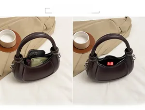 Detailed view of dark brown semi-circular handbag showing interior storage for phone and keys