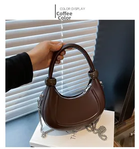 Detailed view of brown hobo bag featuring smooth glossy finish and silver chain strap