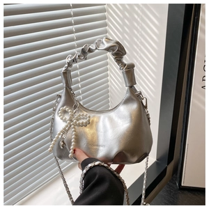 Silver metallic dumpling bag with ruched cloud handle and pearl bow charm detail
