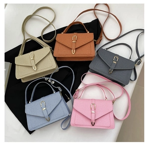 Detail view of multi-color crossbody bags with premium textured leather and gold buckle