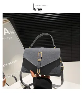 Detailed view of the gray denim texture small square bag with golden horseshoe buckle