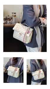 Detail of cream quilted tote bag featuring golden twist lock and pink tassel charm