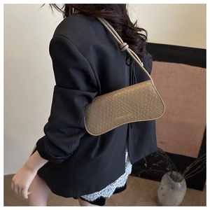 Khaki woven shoulder bag with FASHION & BAGS gold lettering shown on a model