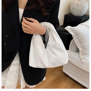 Détail du sac à plis blanc montrant la texture du cuir PU souple et le design minimaliste