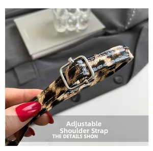 Detail of adjustable leopard print bag strap with silver metal buckle and glossy finish