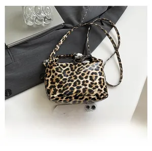 Leopard print mini bag size comparison with a smartphone on professional grey background