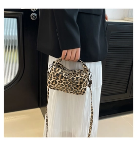 Detail of leopard print tote bag with silver hardware and detachable crossbody strap