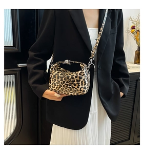 Detail of leopard print crossbody bag with silver buckle and adjustable strap